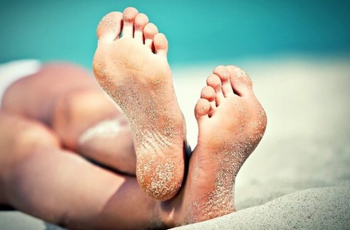 женские ступни в песке